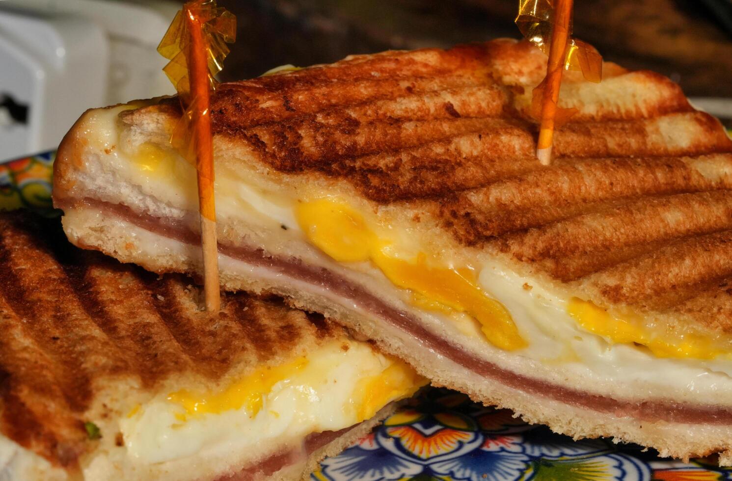 a sandwich with cheese and ham on a plate photo