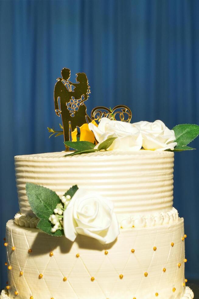 a wedding cake with a couple on top photo