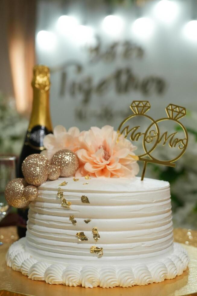 a wedding cake with a gold and white design photo