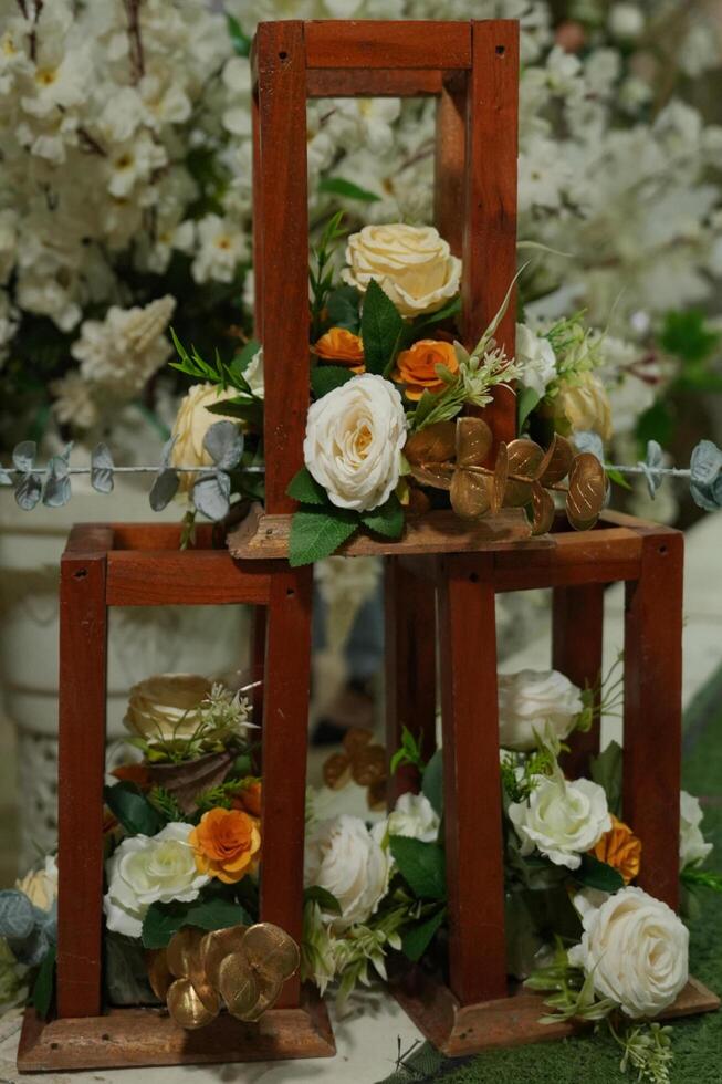 a table with three wooden frames filled with flowers photo