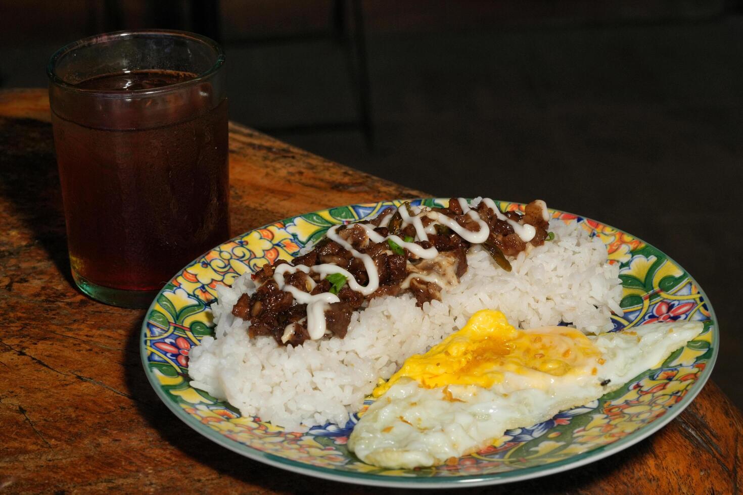 a plate of food with rice and eggs on it photo