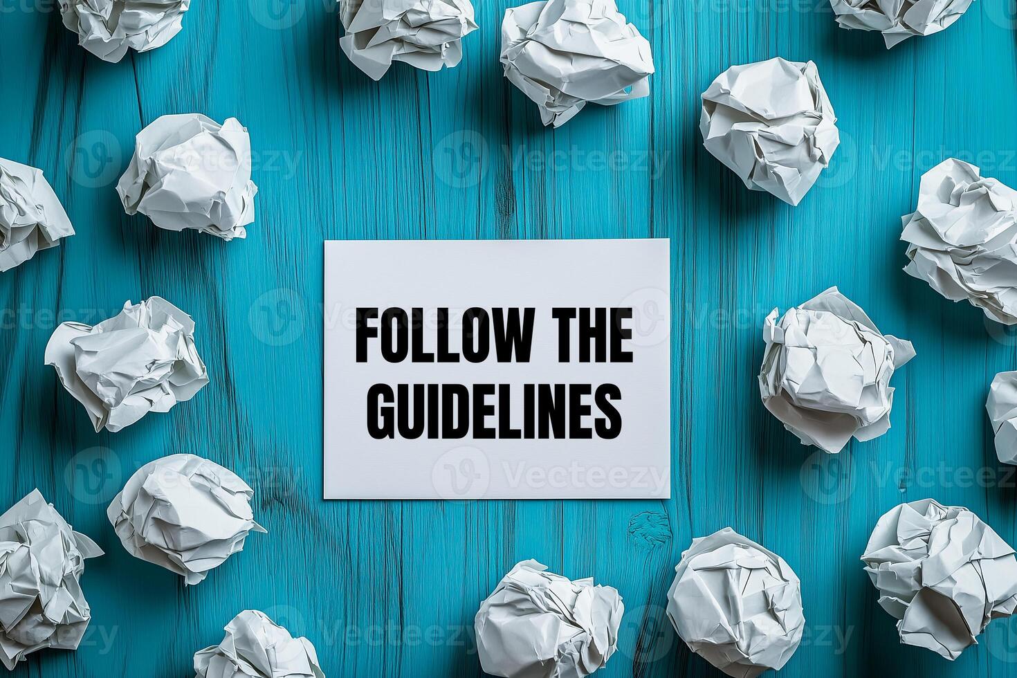 Follow the guidelines message written on white card with crumpled paper balls. Conceptual follow the guidelines symbol. photo