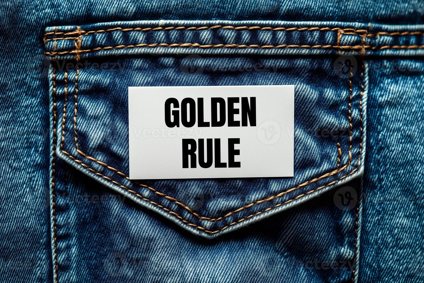Golden rule message written on white card on denim jean background. Conceptual golden rule symbol. Copy space. photo