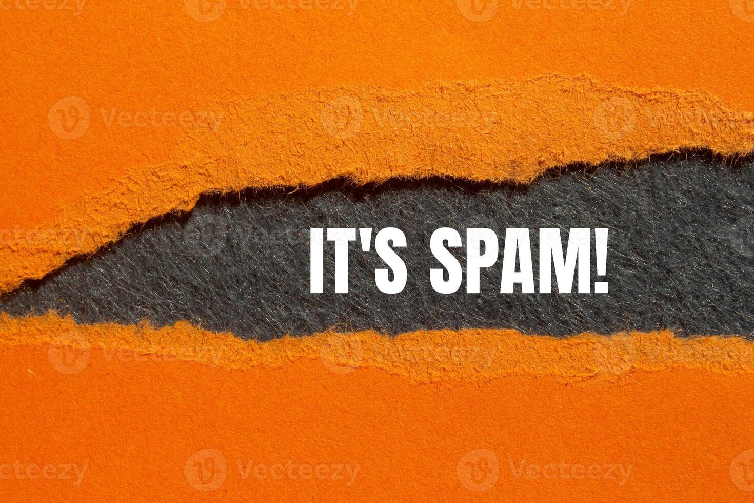 It's spam message written on ripped torn orange paper with gray background. Conceptual it's spam symbol. Copy space. photo