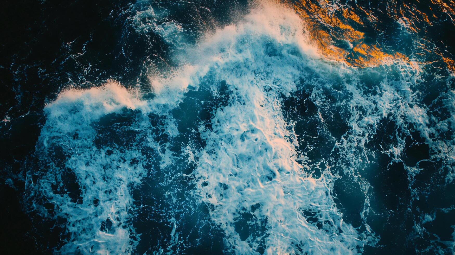The ocean is rough and choppy, with waves crashing against the shore. The water is a deep blue color, and the sky is a dark blue. Scene is one of power and energy photo