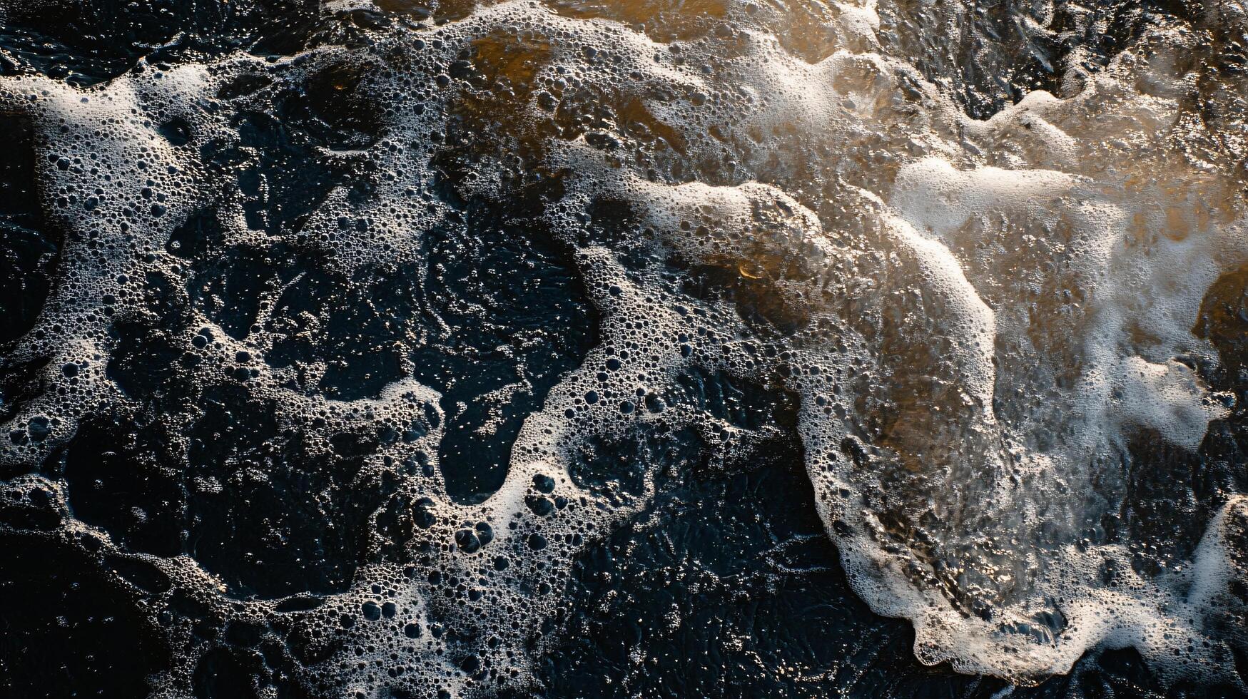 Body of water with a lot of white foam and bubbles. The water appears to be rough and choppy, with waves crashing against the shore. Concept of movement and energy photo