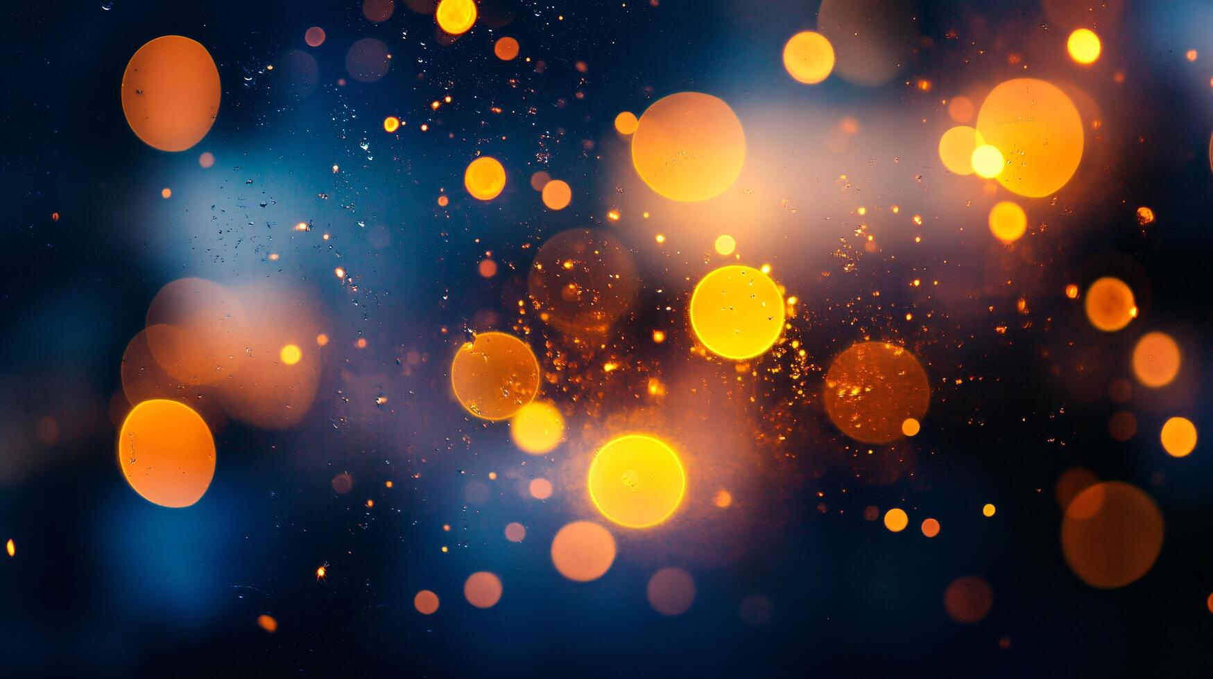 Blurry image of orange and blue lights with a blue background. The lights are scattered and overlapping, creating a sense of movement and energy. Scene is dynamic and lively photo