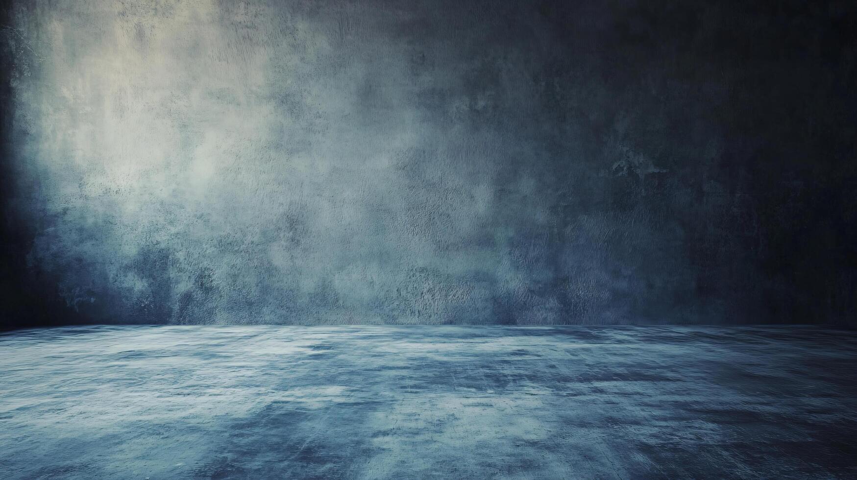 Large empty room with a grey wall. The room is empty and has a very cold and empty feeling photo