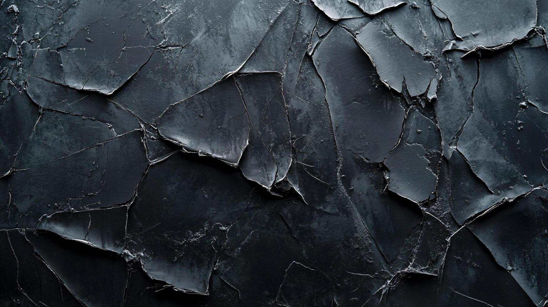Black and white photo of a wall with cracks and holes. The photo has a moody and somewhat eerie feel to it