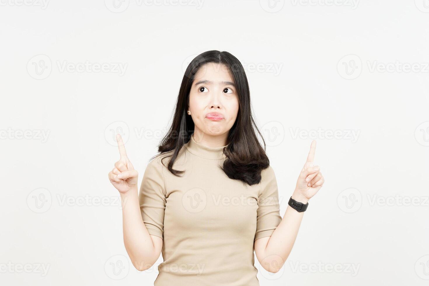 Showing Product and Pointing Up Of Beautiful Asian Woman Isolated On White Background photo
