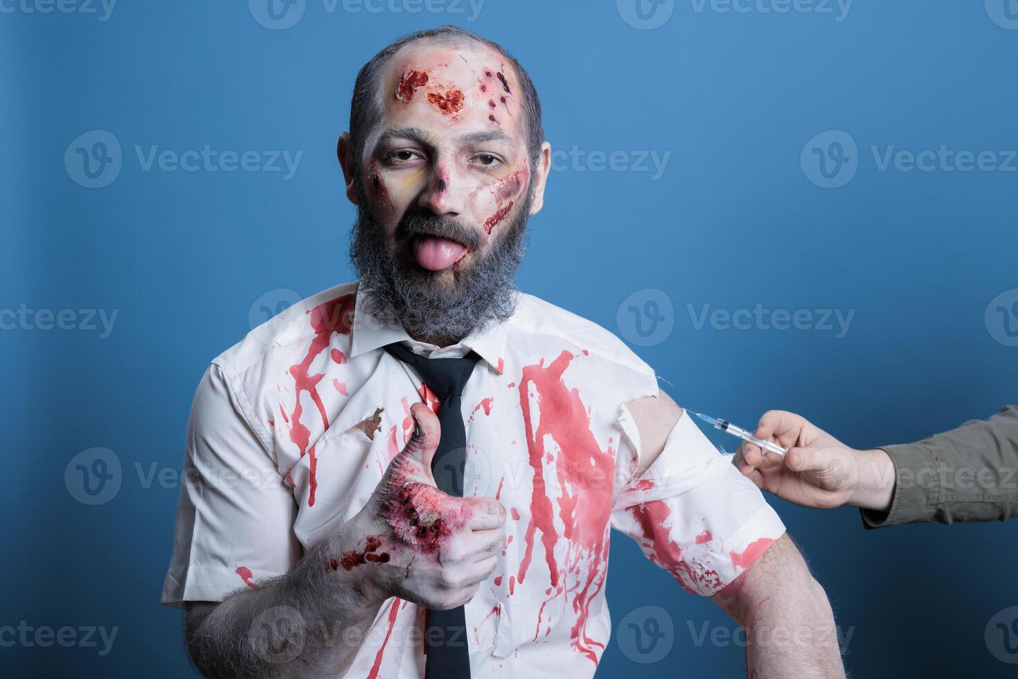 Man covered in scars receiving antitoxin vaccine after being mauled by feral animals, showing thumbs up gesturing during recovery. Wounded person getting antiseptic medicine dose, studio background photo