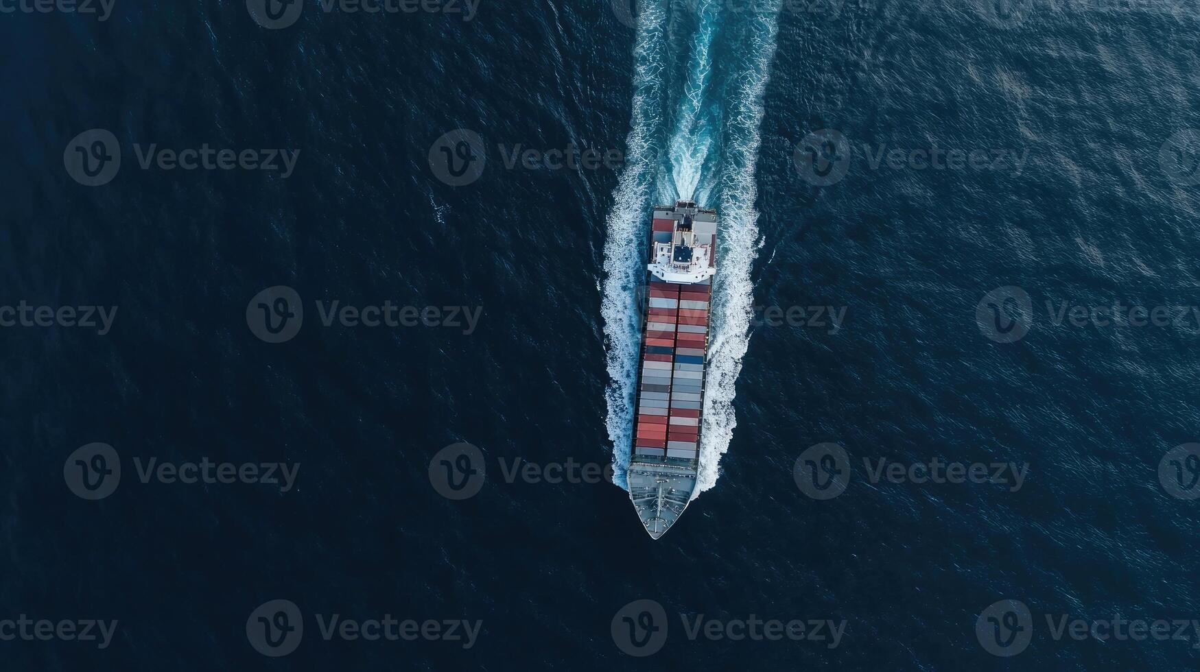 An aerial view of a cargo ship traveling across the ocean photo