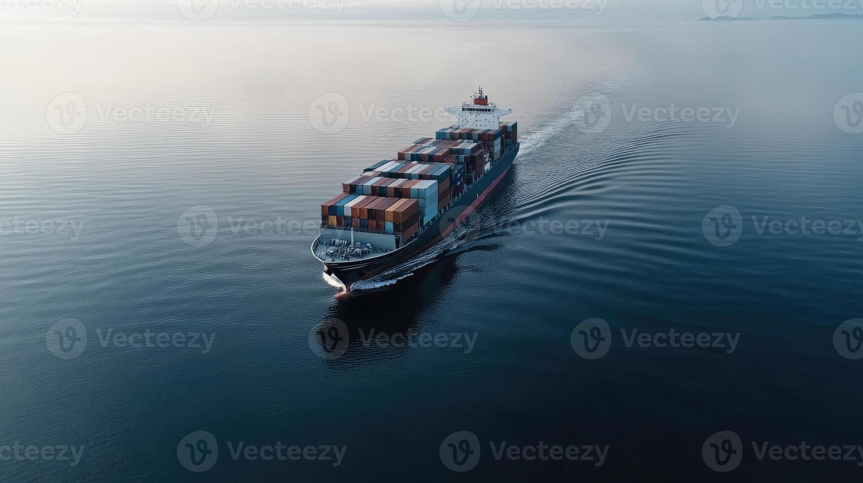 An aerial view of a container ship traveling across the ocean photo