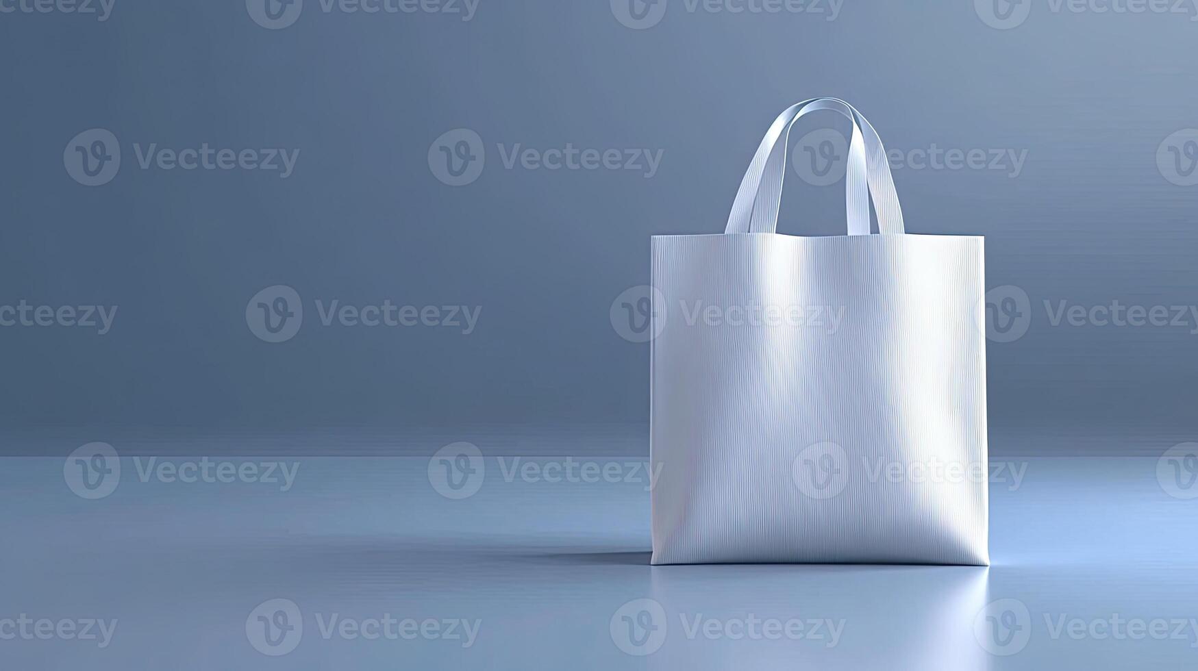 A white shopping bag on a blue surface photo