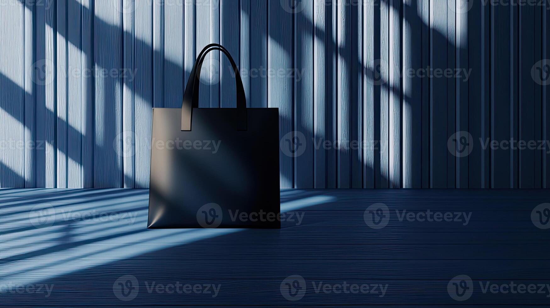 A black bag sitting on a wooden floor photo