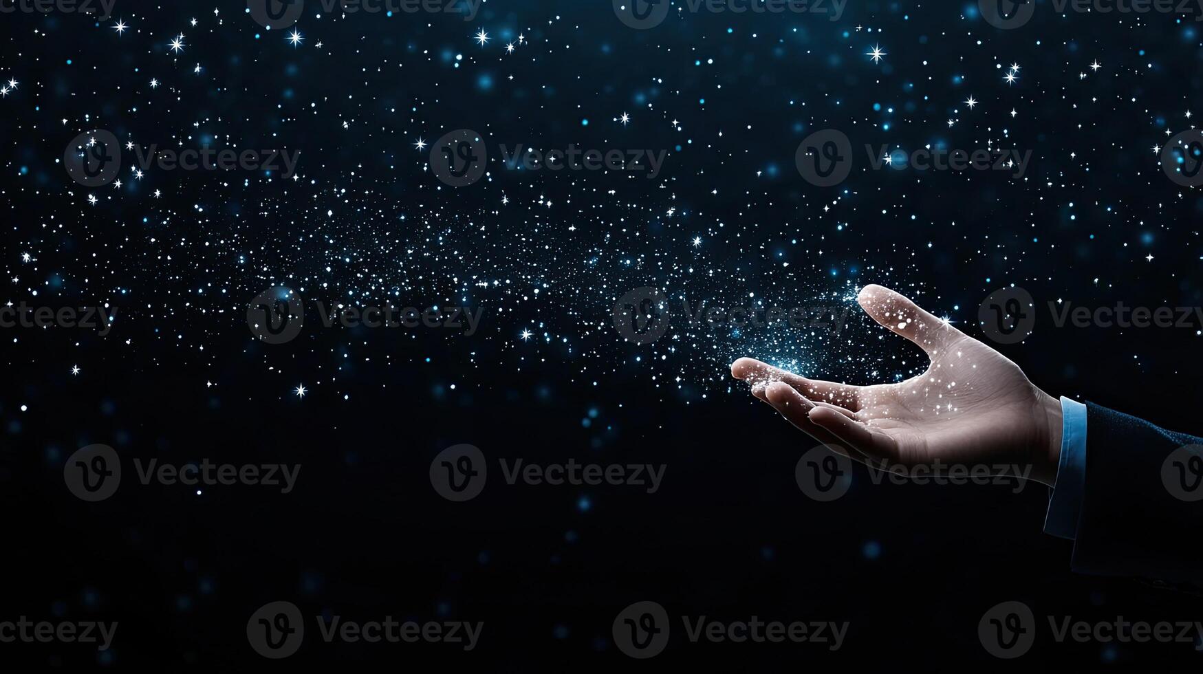 A hand reaching out to the sky with snow falling photo
