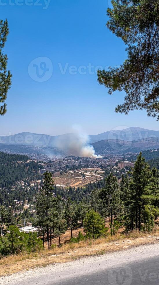 A view of a fire in the distance from a highway photo