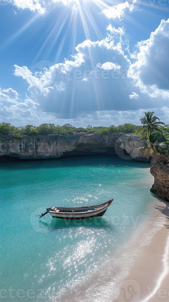 A boat is sitting on the beach near a cave photo