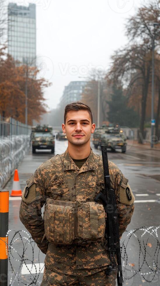 A soldier standing in front of a fence photo