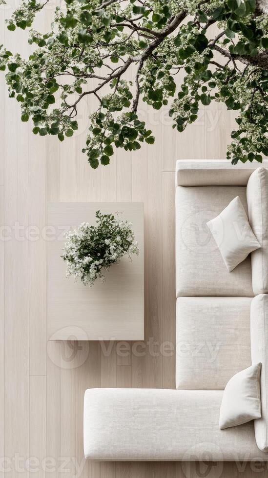 A white couch and a tree in a room photo