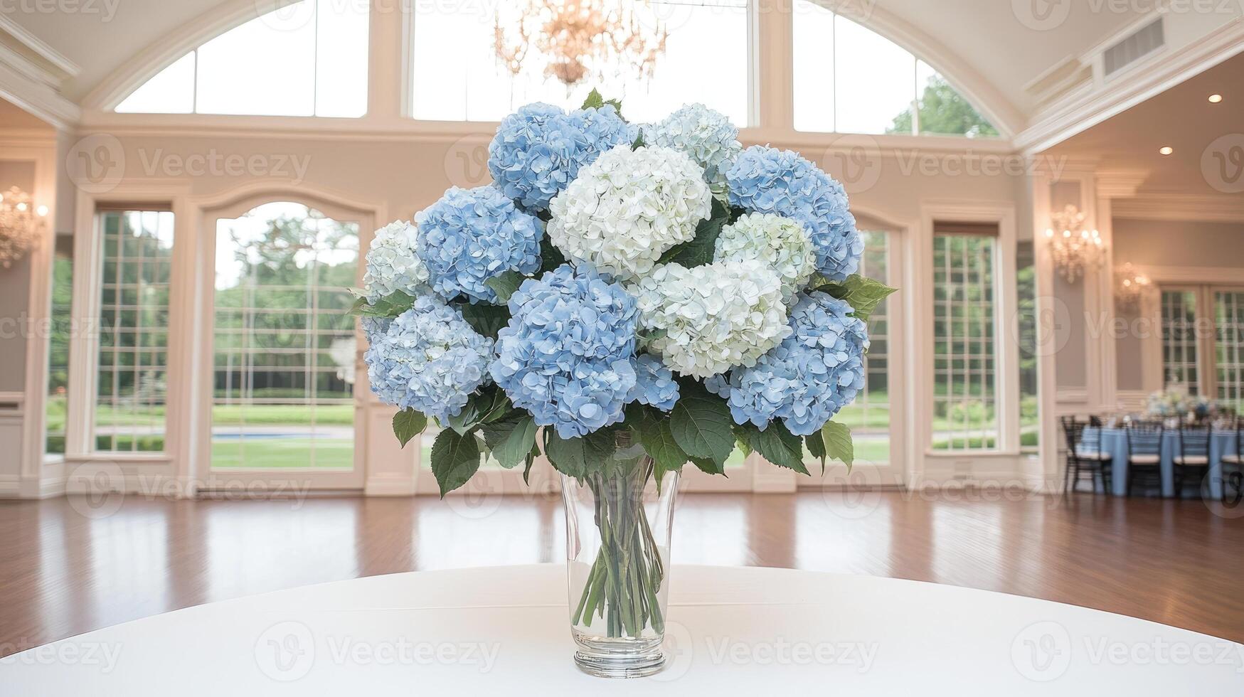 A vase of blue flowers sits on a table in a large room photo