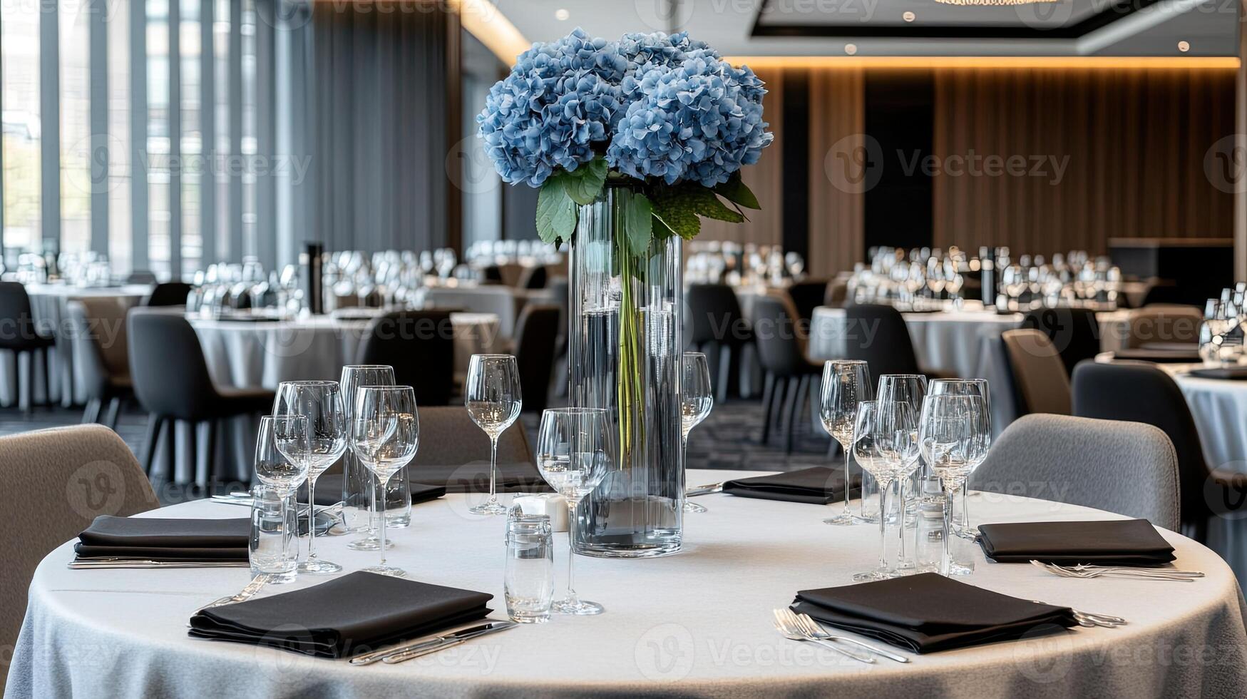 A table with white linens and black chairs photo
