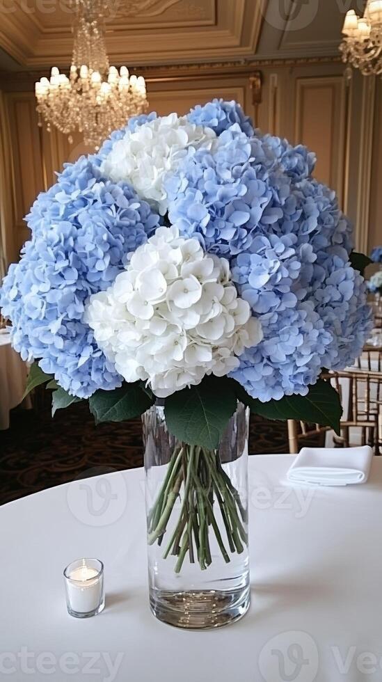 A vase filled with blue and white flowers on a table photo