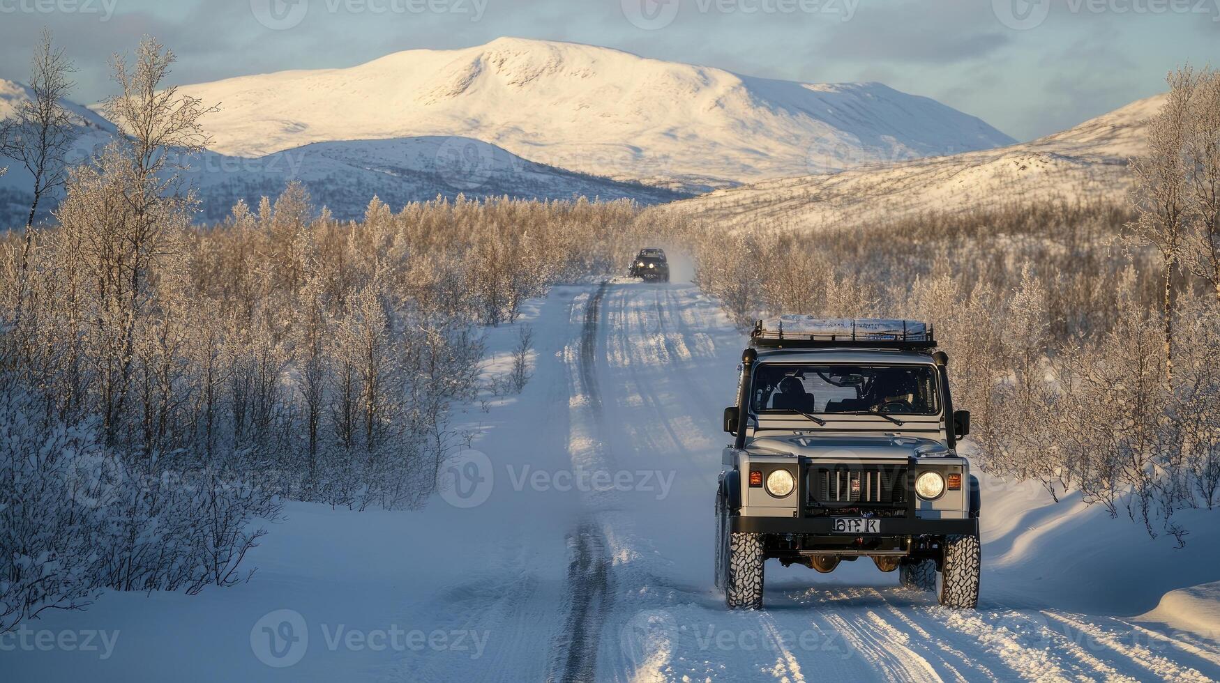 A jeep driving down a snowy road with trees and mountains in the background photo