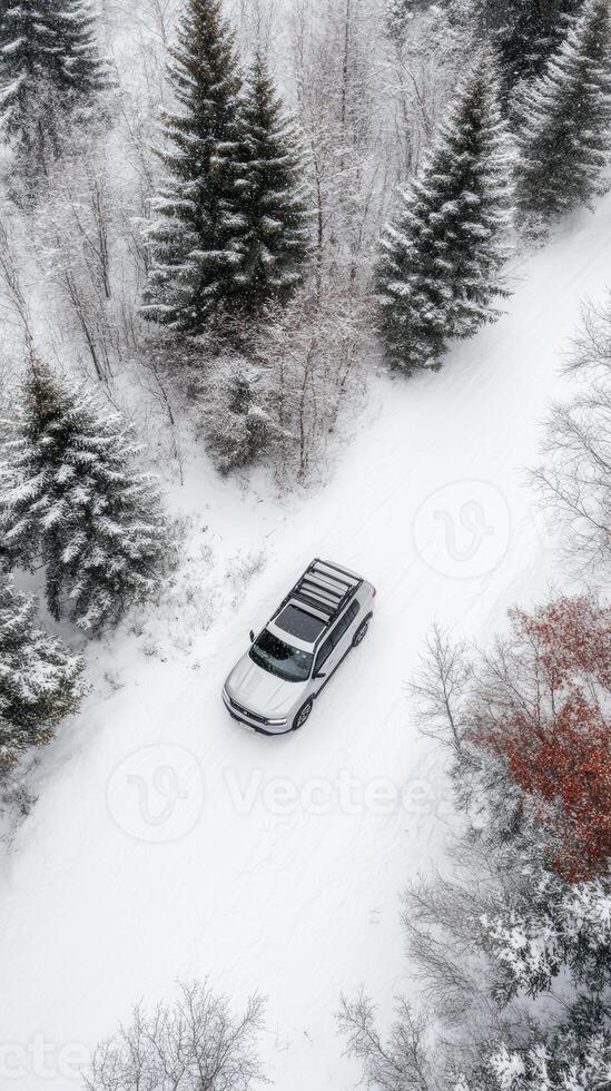 A car driving through the snow on a snowy road photo