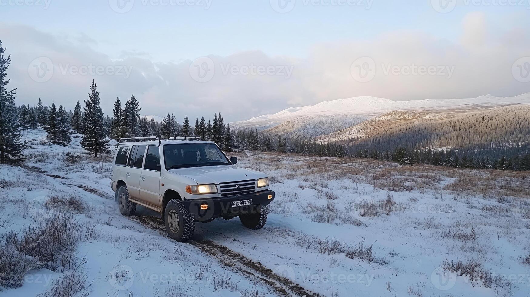 A white suv driving on a snowy road photo