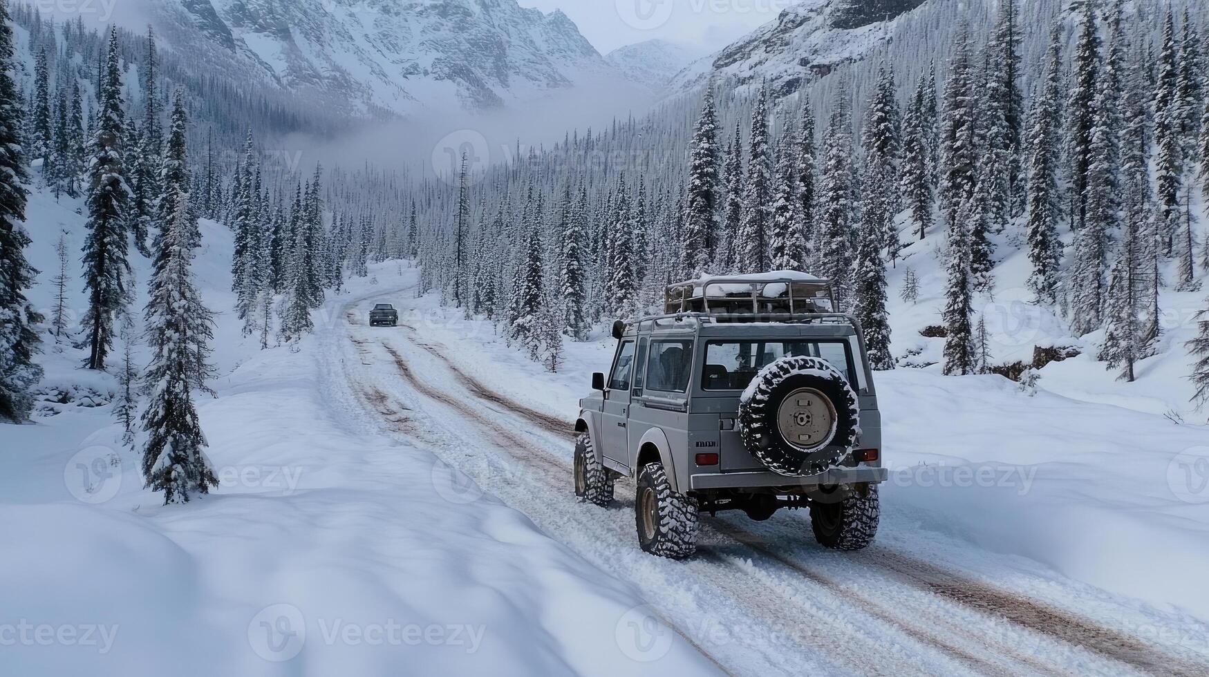 A jeep driving down a snowy road in the mountains photo