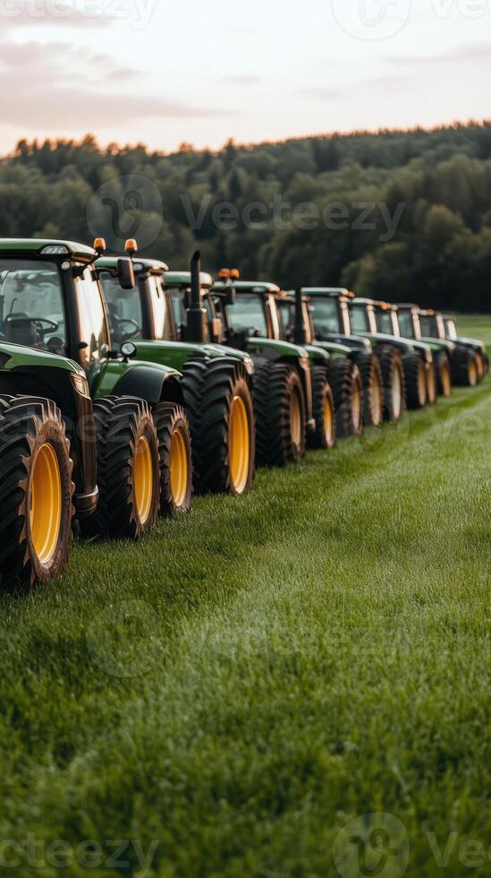 A row of green tractors parked in a field photo