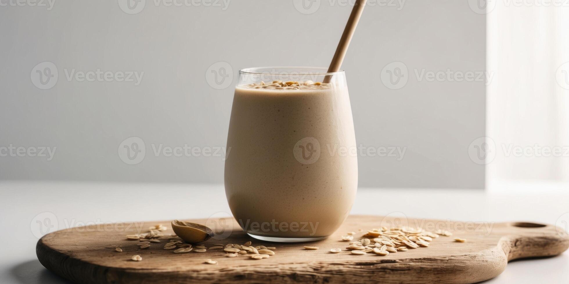 Banana peanut smoothie with oats on wooden board. photo