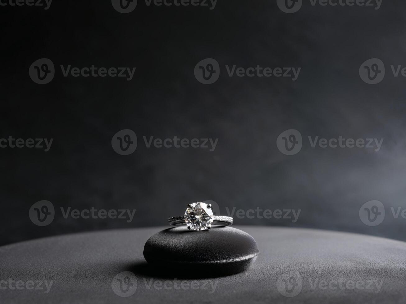 Elegant diamond ring on dark charcoal background. photo