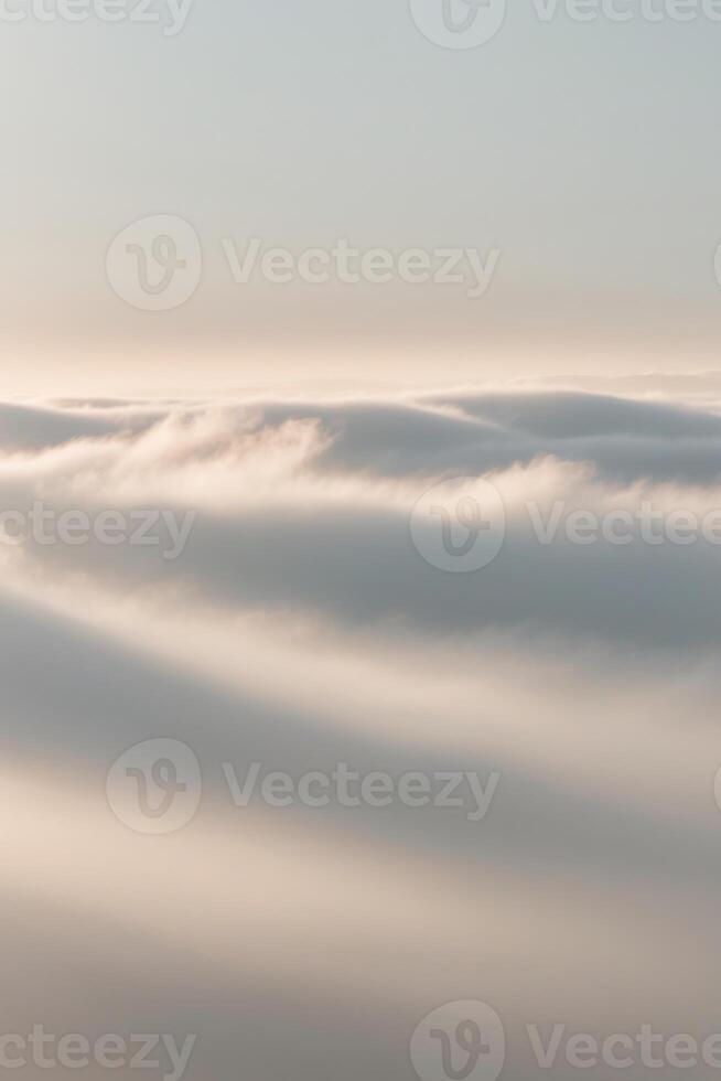 A serene landscape featuring soft clouds and gentle lighting in pastel shades of color. photo