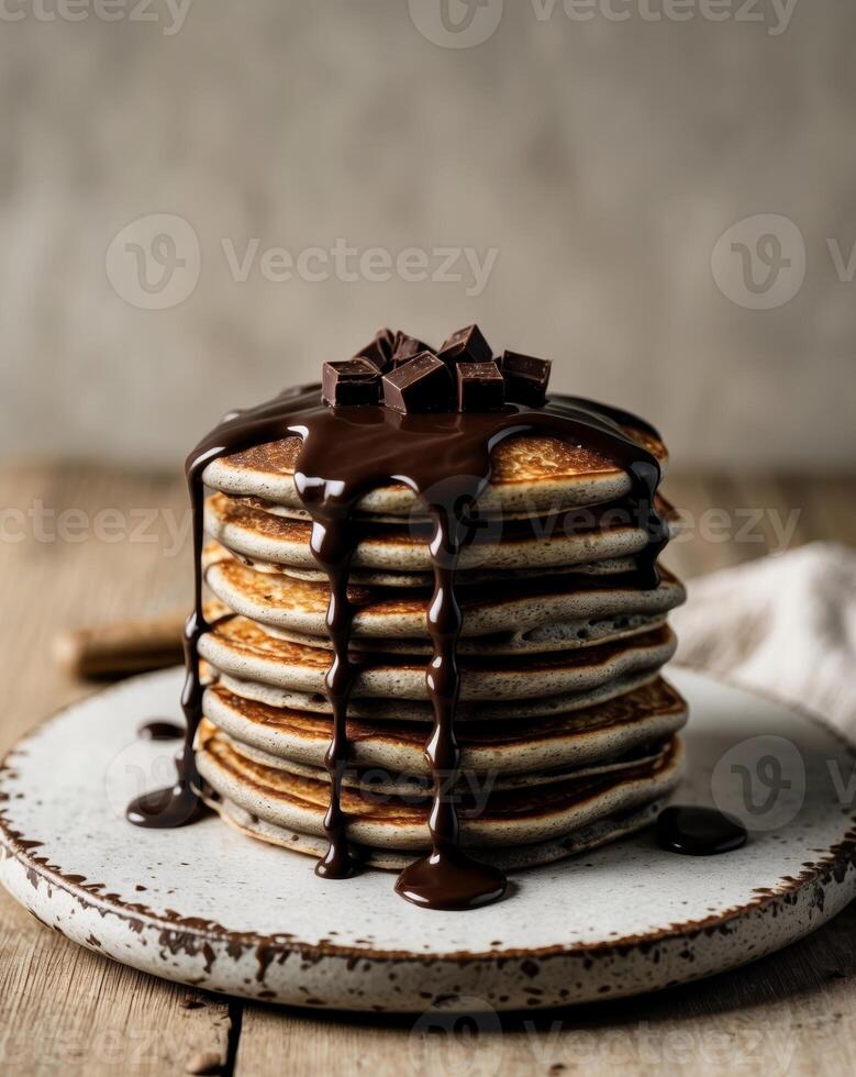 Stack of pancakes with chocolate drizzle on top photo