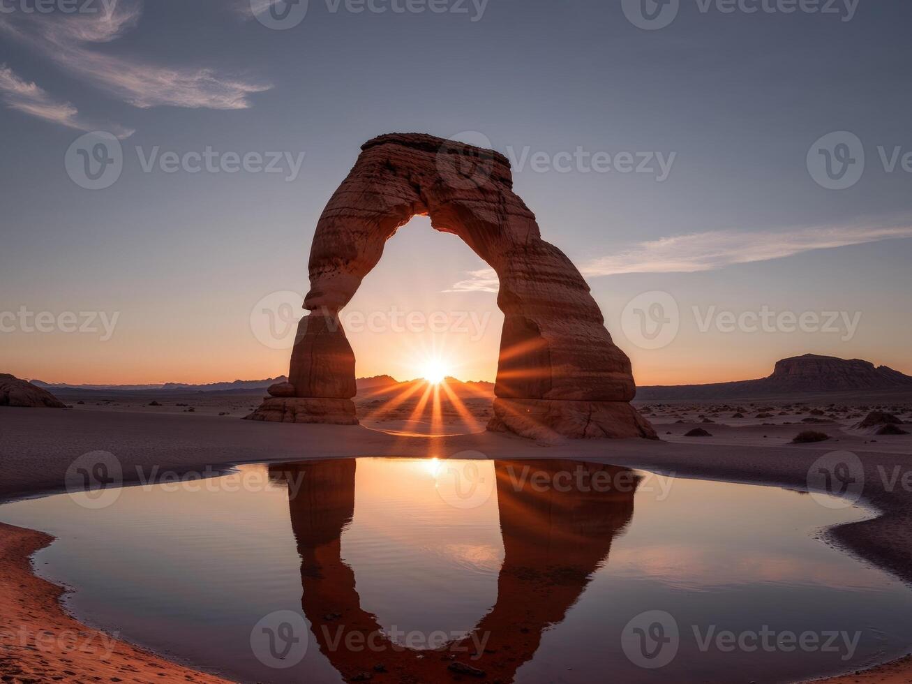 Majestic Sunrise Over Desert Arch Reflecting in Tranquil Waters photo