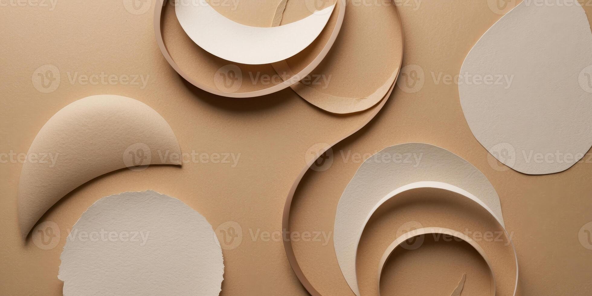 Paper cutouts of circles and shapes on a beige background photo