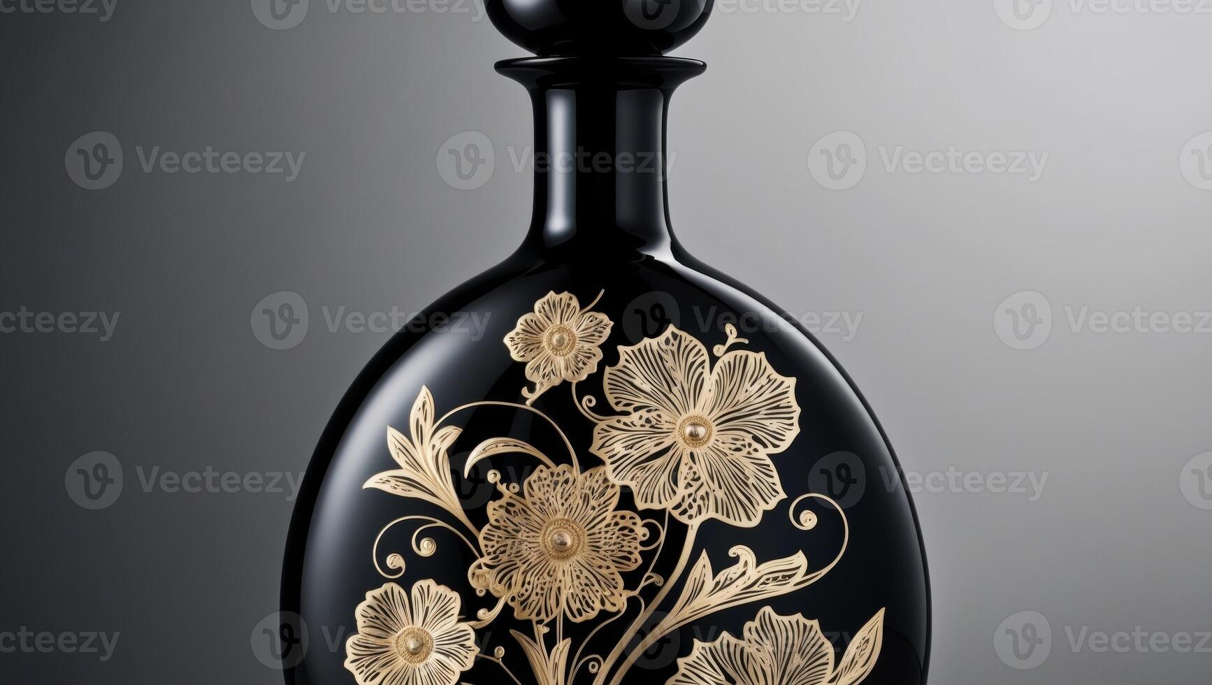 A black and gold bottle with flowers on it photo