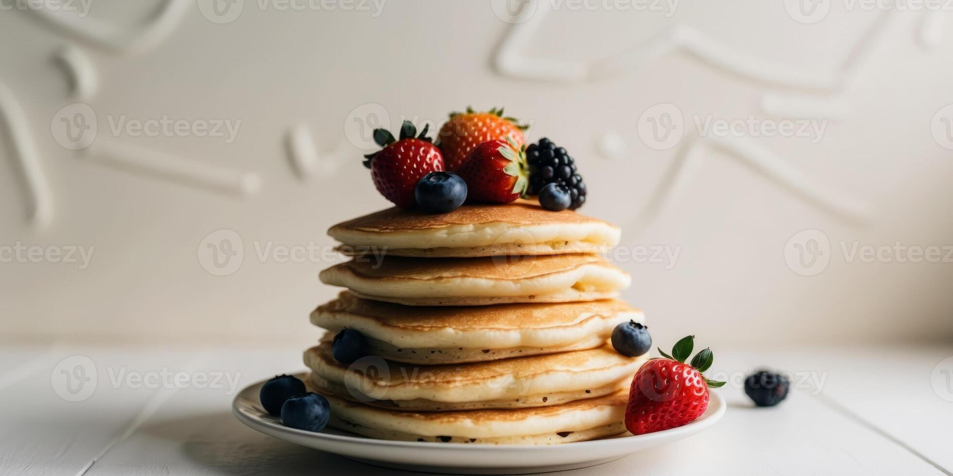Stack of pancakes with berries and strawberries photo