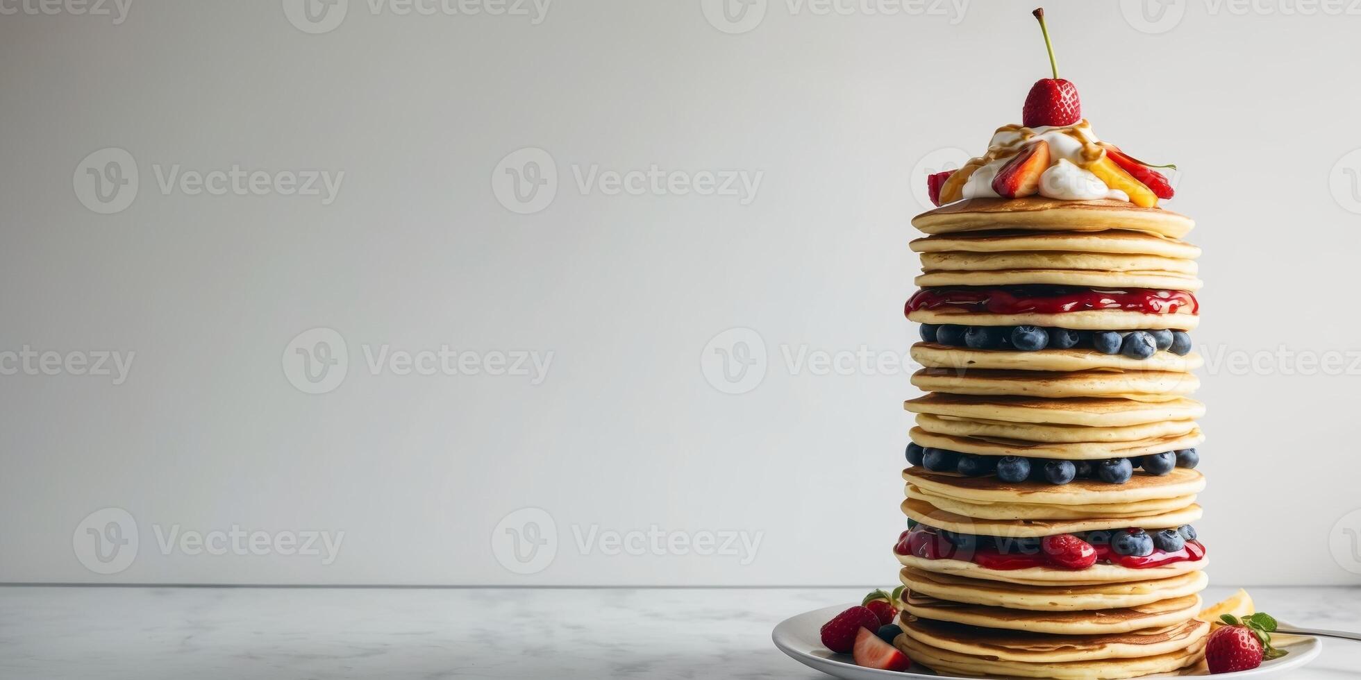 A stack of pancakes with fruit and syrup photo