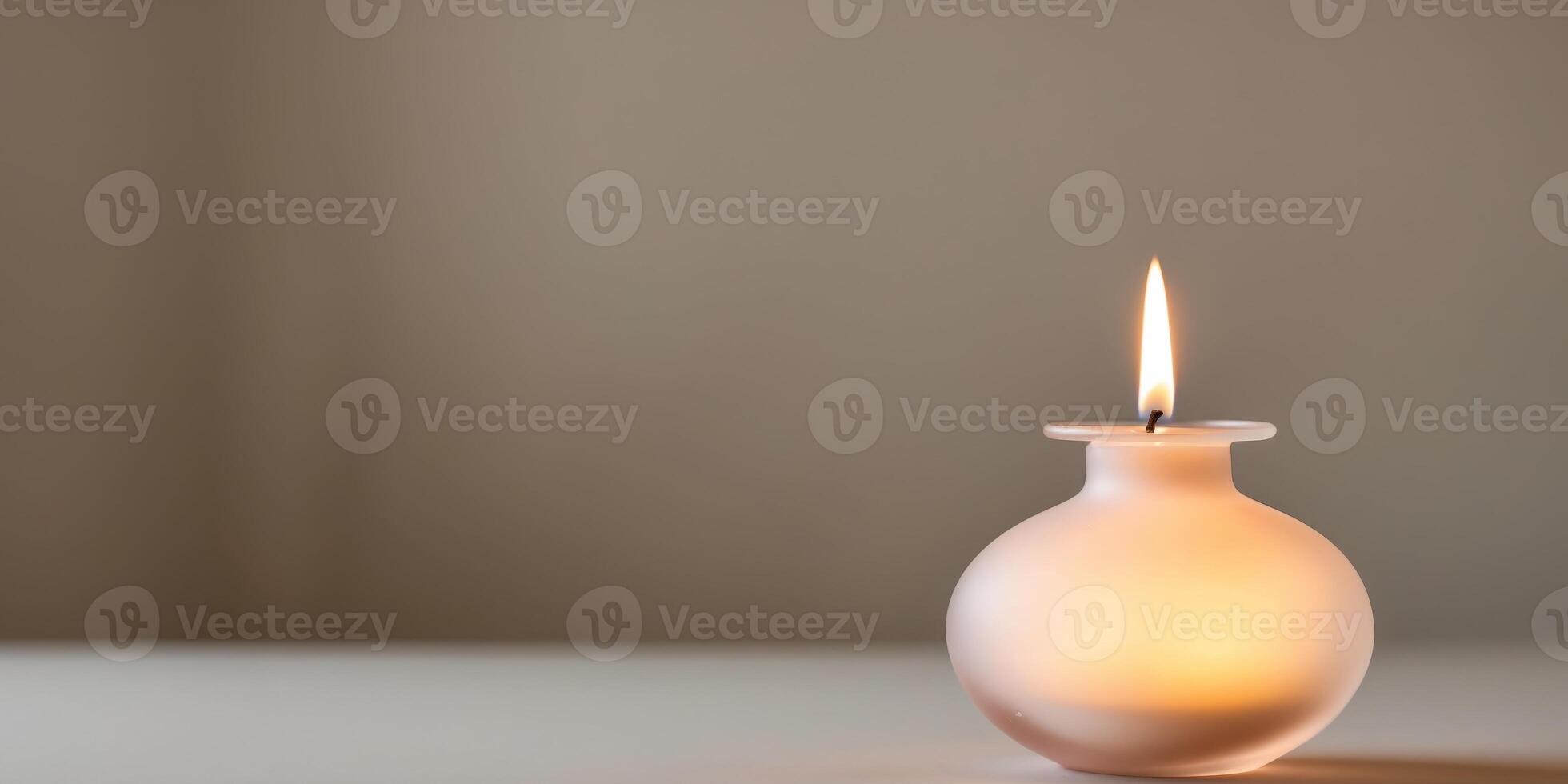 A small vase with a lighted candle inside of it photo