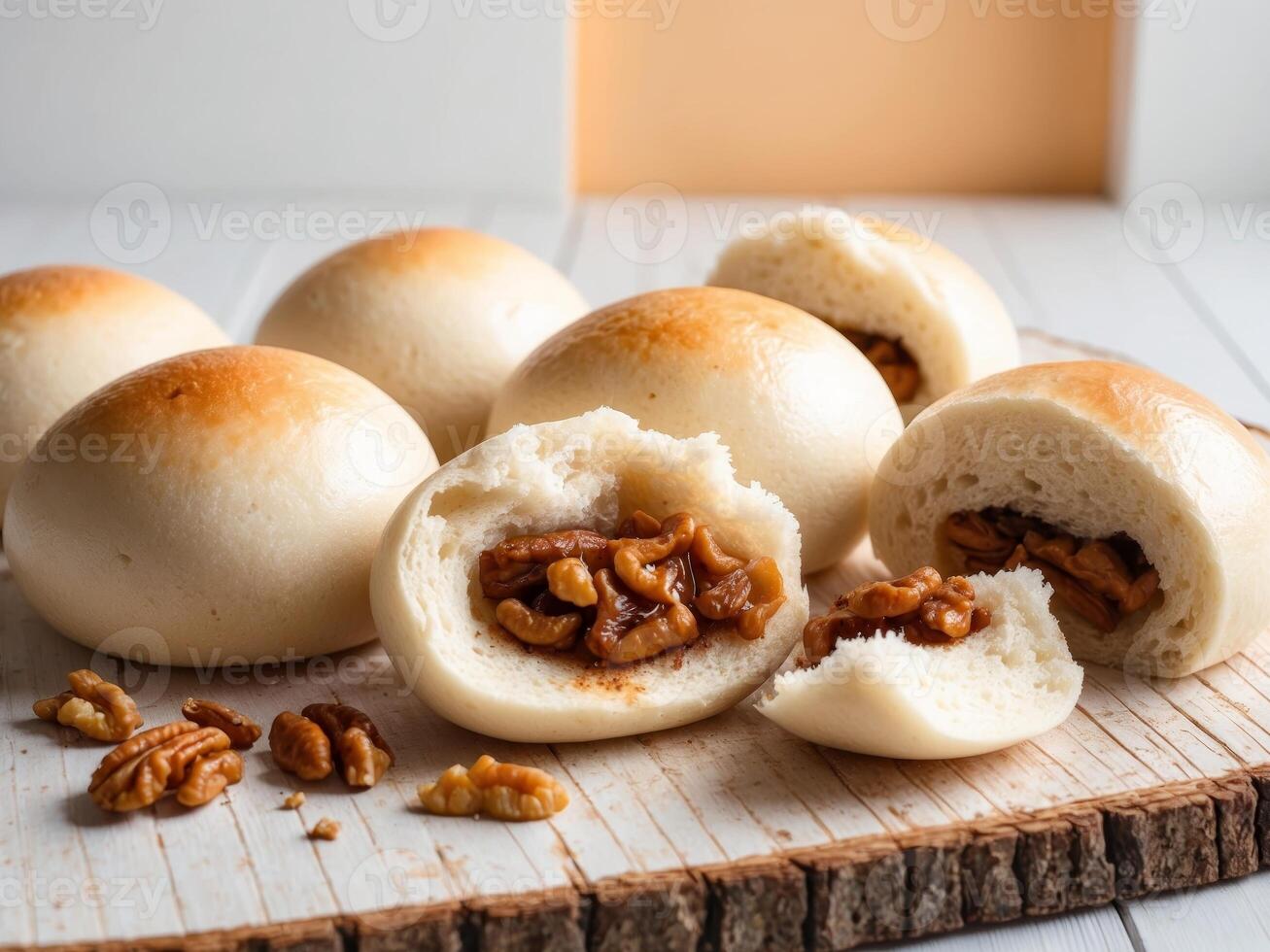 Buns with walnuts and nuts on a wooden cutting board photo