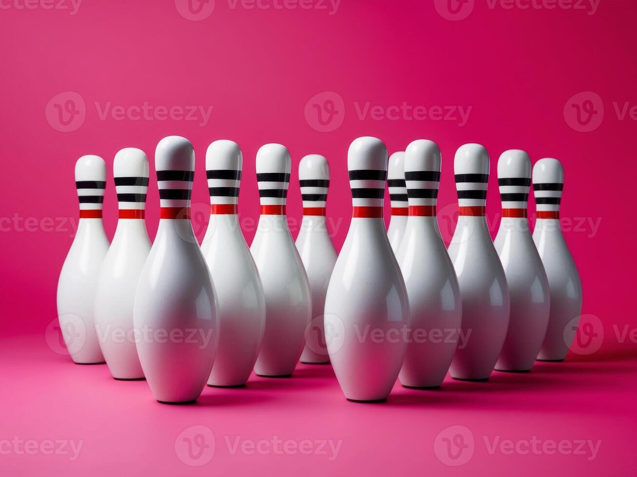 Bowling pins arranged on a bright pink background for a vibrant recreational setting photo