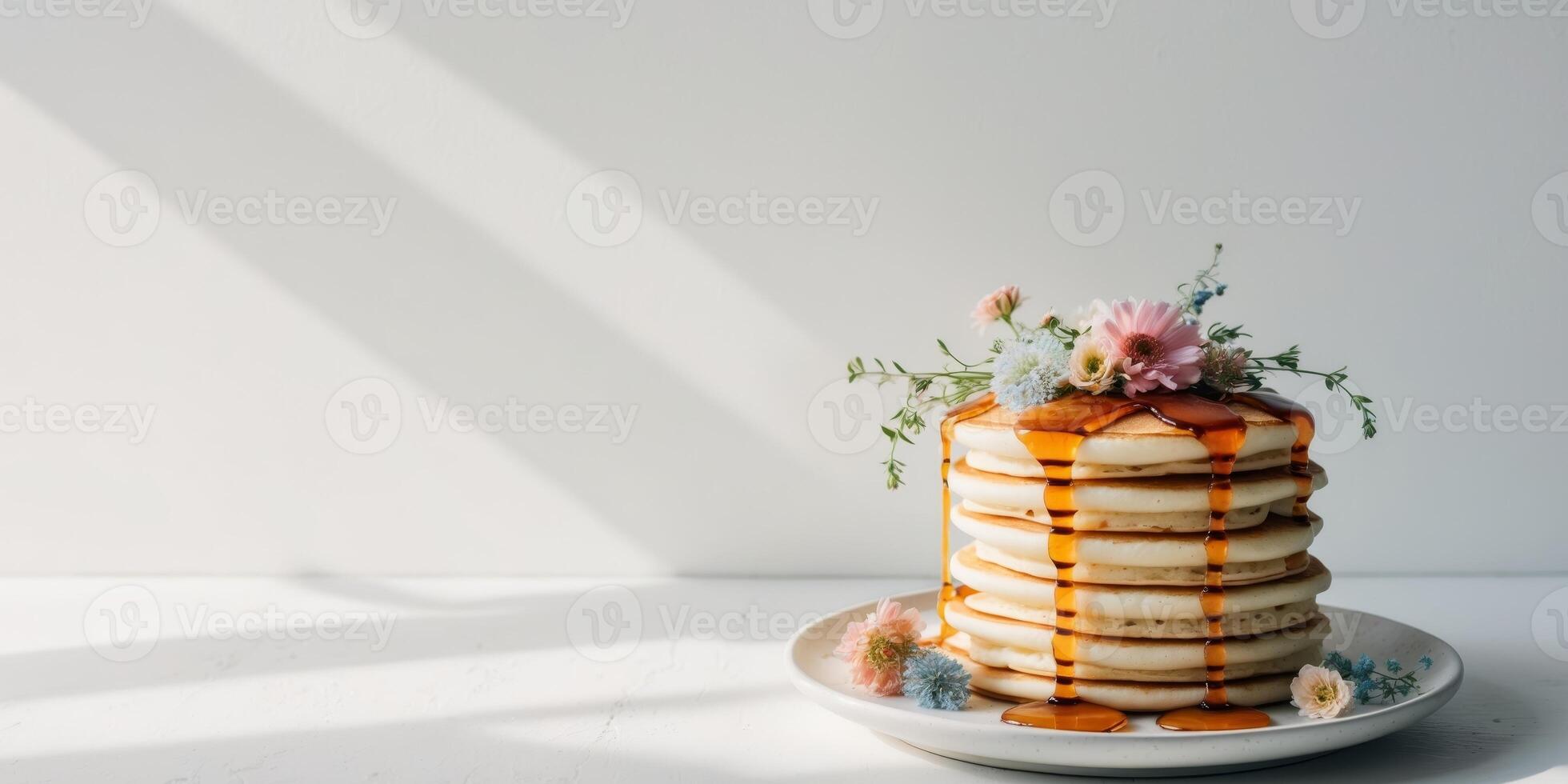 Stack of Pancakes with Flowers and Syrup Drizzle photo