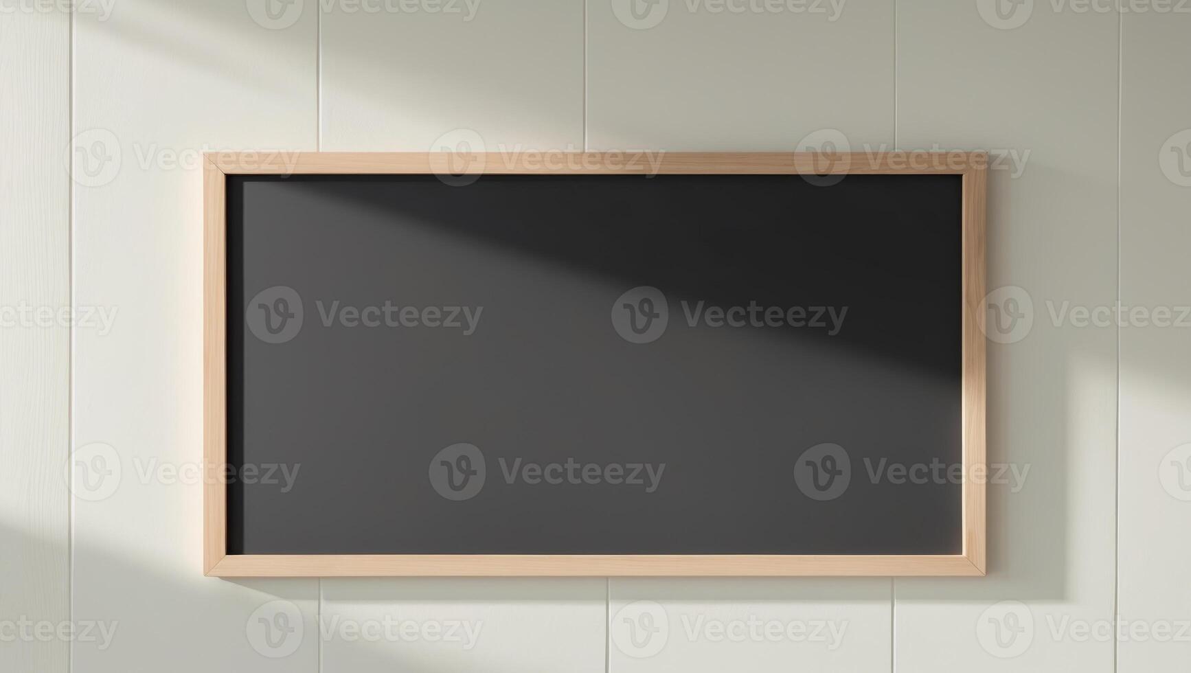 blank chalkboard with wooden frame on clean wall photo