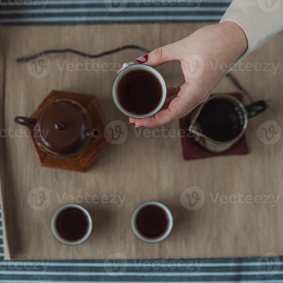 A beautiful and elegant tea ceremony featuring a traditional teapot and matching tea cups photo