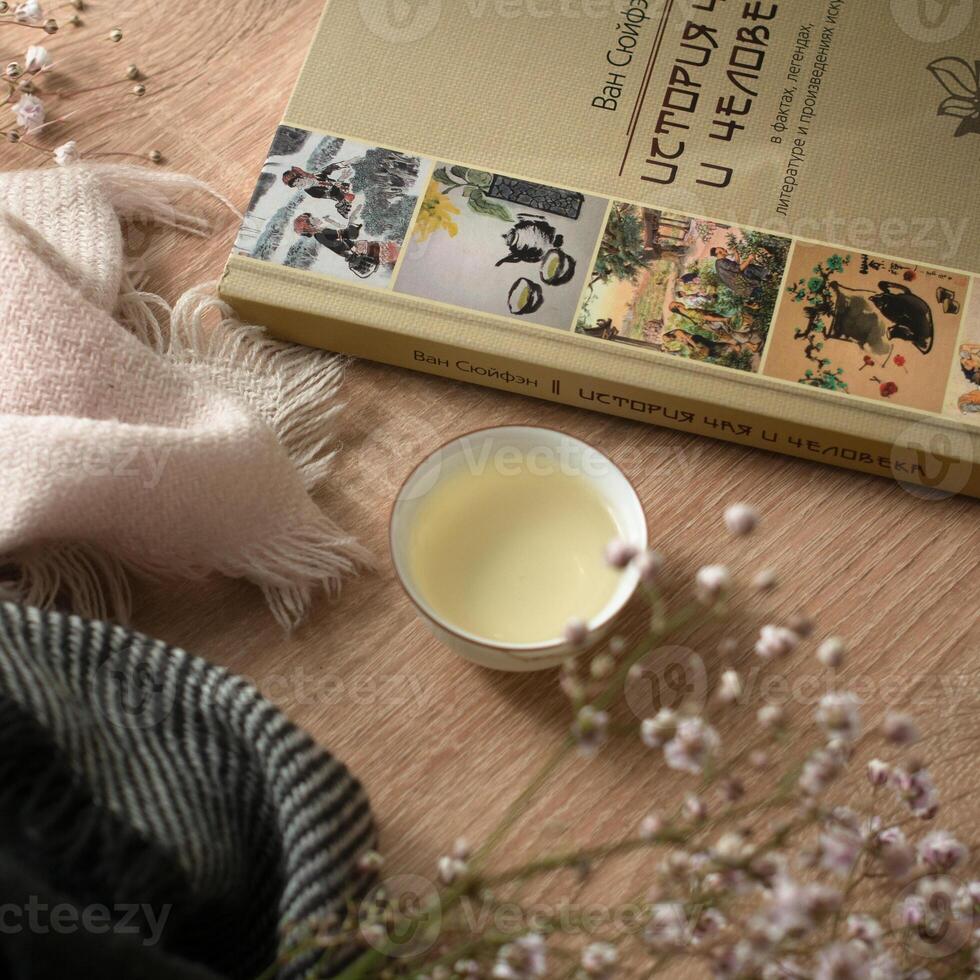 A Cozy Reading Corner with a Book and a Beautiful Candle for the Perfect Ambiance photo
