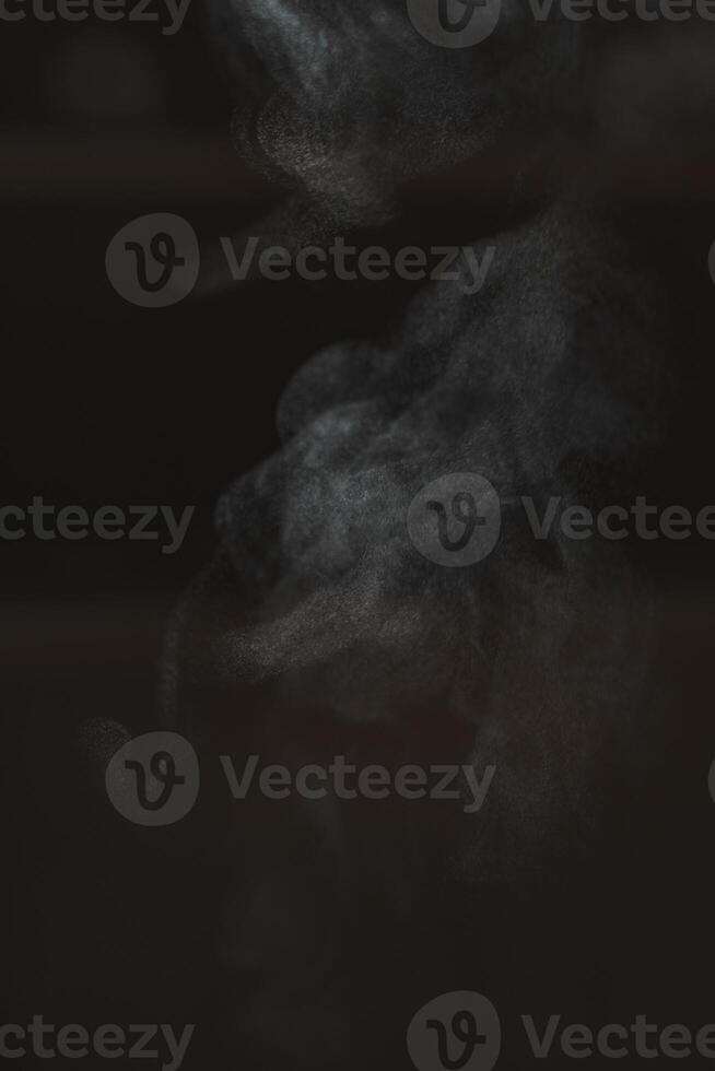 Mysterious Smoke Swirls Elegantly on a Dark Background Creating an Enigmatic Atmosphere photo