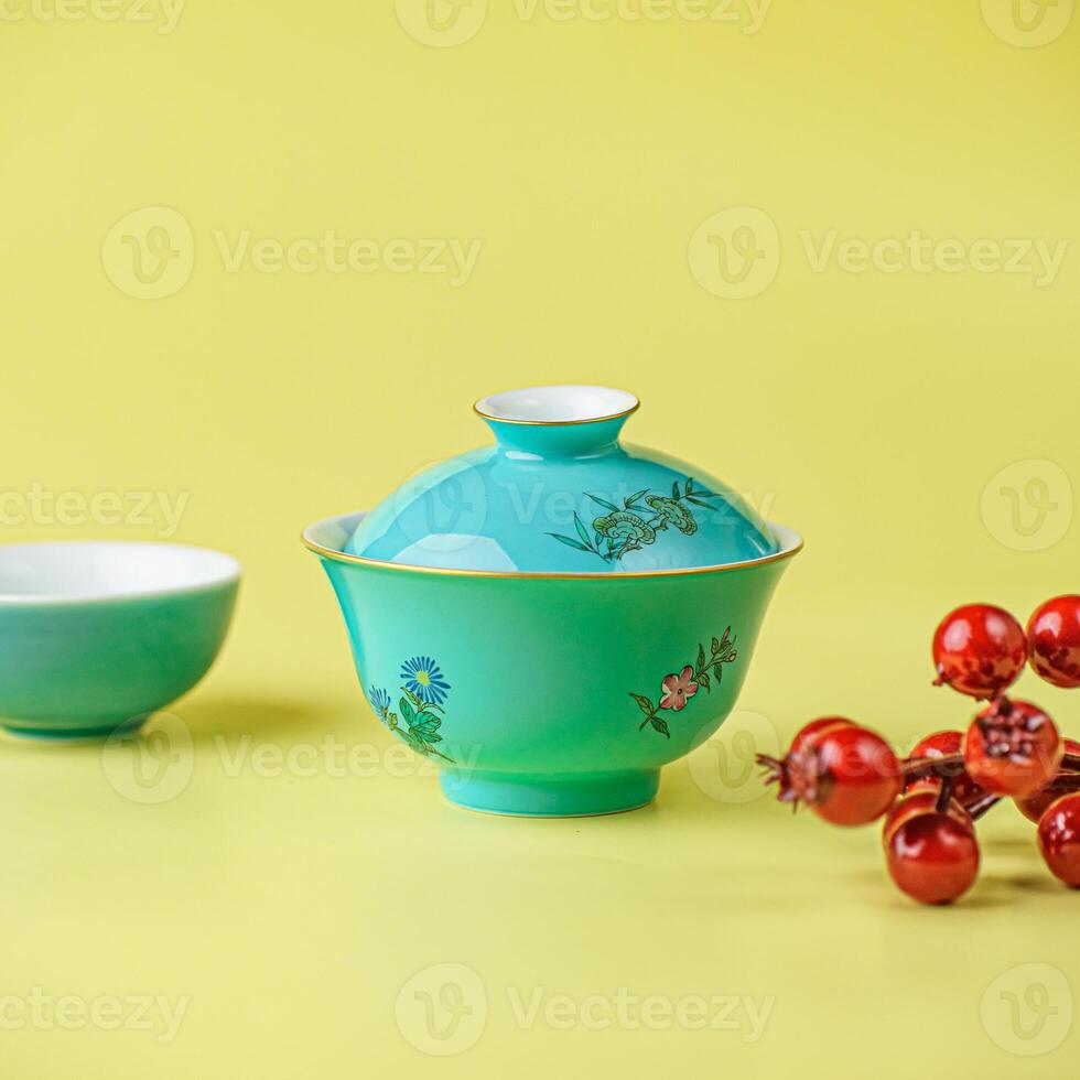 An Exquisite and Elegant Porcelain Tea Set Displayed on a Vibrant Yellow Background photo